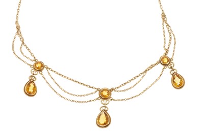 Lot 714 - Edwardian style gold and citrine fringe necklace with pear-cut citrine drops suspended from round mixed-cut citrines with gold chain link swags, 39cm.