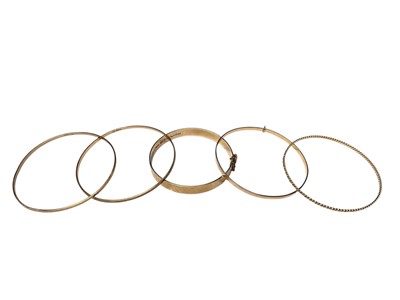 Lot 204 - Three 9ct gold bangles and two yellow metal bangles (5)