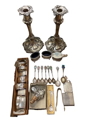 Lot 992 - Silver three piece condiment set with blue glass liners, Continental silver souvenir spoons, white metal napkin rings, pair of Victorian silver plated candlesticks and other plated items