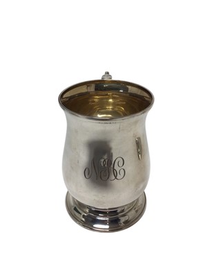 Lot 470 - Contemporary silver mug of baluster form, with engraved initials and leaf mounted scroll handle, raised on a circular foot, (London 1956), maker Cohen and Charles, 13cm overall height, all at 10...