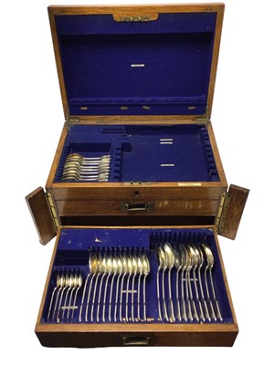 Lot 479 - George V silver canteen of fiddle, shell and thread pattern cutlery comprising, x10 teaspoons, x11 tablespoons, x12 dessert spoons, x5 egg spoons, x12 table forks, x10 dessert forks x2 sauce lad...