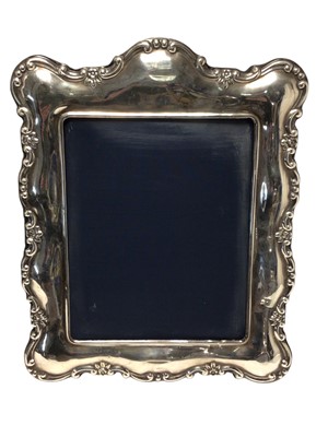 Lot 506 - Large contemporary silver photograph frame of rectangular form with scroll borders and easel support, (Sheffield 1991), maker John Bull Ltd, 39 x 30cm overall.