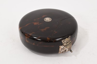 Lot 841 - Early tortoiseshell and silver mounted table snuff box, of domed form with central boss and ornate lock, elaborate old repair to the cover, probably late 17th/early 18th century, 13cm diameter