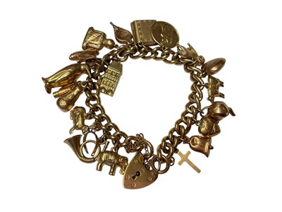 Lot 115 - 9ct gold curb link novelty charm bracelet with padlock clasp
