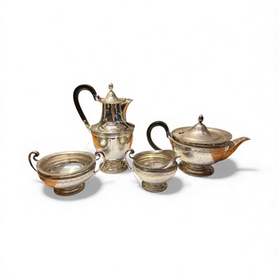 Lot 156 - George V silver four piece teaset comprising teapot of cauldron form, raised on a circular foot, the body with band of engraved decoration and engraved initial 'L'