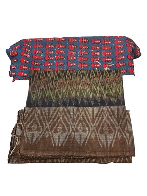 Lot 2534 - A group of vintage fabrics including a large piece of Banjari woven and embroidered fabric, block printed lengths and woven Ikat cloth.