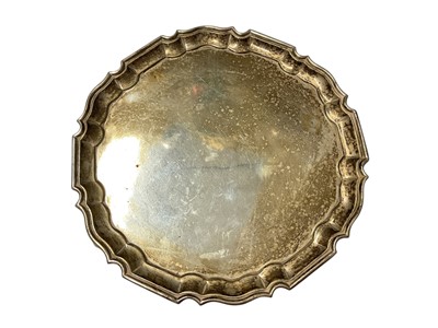 Lot 167 - George V salver with piecrust border, raised on three hoof feet, (London 1918), maker Charles Stuart Harris, 26cm in diameter, all at 19ozs.