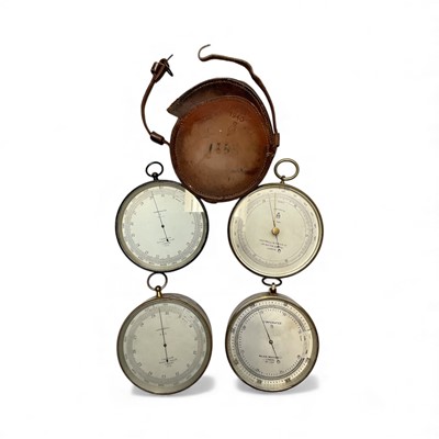 Lot 2950 - Group of four aneroid compensated barometers, one leather cased, two with broad arrow marks, various makers, each approx 12cm diameter