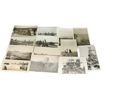 Lot 746 - Collection of Naval photographs and photographic cards showing war damage, action with direct hits, sinking vessels and other similar views, many with annotations on reverse. (13)