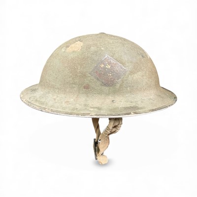 Lot 748 - Second World War MK2 pattern steel helmet with camouflage painted finish and formation patch, dated under brim 1940.