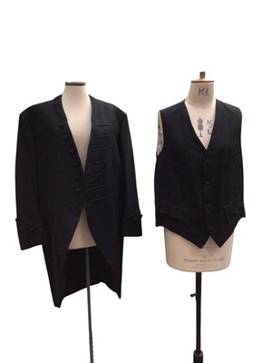 Lot 2543 - Vintage legal tailoring by Ede & Ravenscroft Court Coat single breasted with stand collar, button and braid to front, one hook and eye fastening. Pockets to breast and in tails, buttons to...