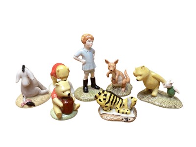 Lot 2255 - Seven Royal Doulton Winnie the Pooh Collection figures including Christopher Robin, Pooh and the honeypot, Eeyore's Tail, The Windy Day, Winnie the Pooh and the paw-marks, Kangaroo and Roo, and...