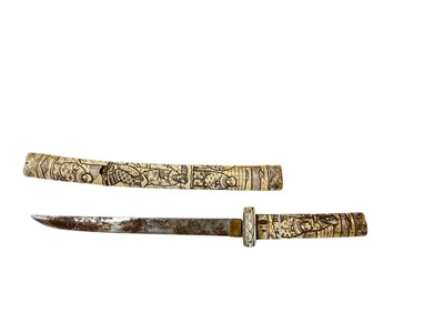 Lot 859 - Late 19th Japanese tanto dagger in an ornately carved bone scabbard, with similar grip, the blade 24cm in length.