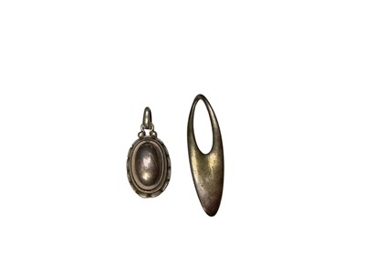 Lot 52 - Two Georg Jensen Danish silver pendants to include an oval cabochon, no. 2001 and abstract oval, no. 500 (2)
