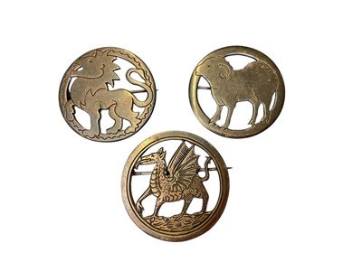 Lot 65 - Three 1930s silver circular brooches depicting a dragon, a lion and a sheep by Henry George Murphy, all bearing the Falcon studio mark, 32mm diameter