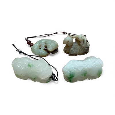 Lot 3107 - Four Oriental green stone netsuke