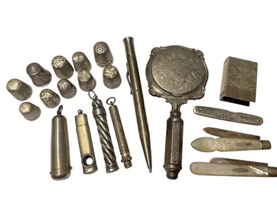 Lot 90 - Group of small silver items to include a collection of thimbles, silver and mother of pearl fruit knives, propelling pencils and a pen, cheroot holder, cigar cutter and a sterling matchbox holde...