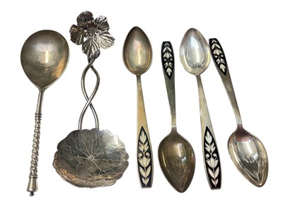 Lot 97 - 1960s silver spoon by R.E. Stone, contemporary silver spoon with stylised flower head and leaf decoration and a set of four white metal and enamel spoons