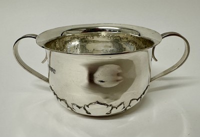 Lot 106 - George V silver two handled porringer with twin reeded handles and leaf foliate border (Chester 1911), 5.1ozs