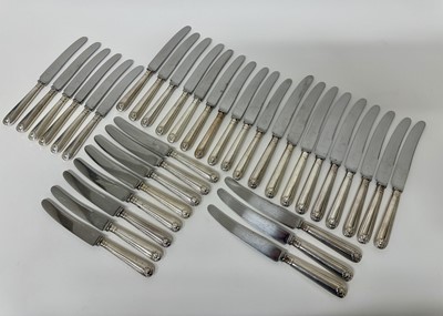 Lot 123 - Set of twelve silver plated shell and thread pattern dinner knives and twenty-four matching dessert knives