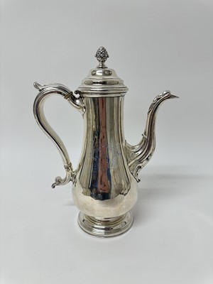Lot 120 - Late 19th century silver plated coffee pot of baluster form, with engraved initials, leaf mounted spout, hinged domed cover and silver plated handle, with ivory insulators, on a circular base (c...