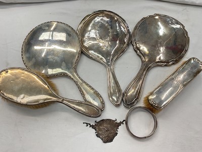 Lot 950 - Group of antique silver backed dressing table items to include three hand mirrors and two brushes, silver mount and a silver (925) bangle