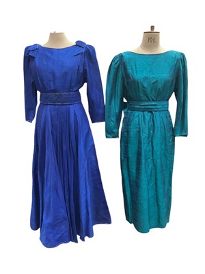 Lot 2558 - Designer Anna Belinda two 1980s dresses blue and green slub silk with sashes and bow details.
