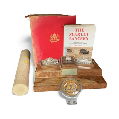 Lot 734 - Elizabeth II Queen's Royal Lancers chromium plated car badge, together with two reference books and a mahogany desk stand mounted with tanks and engraved presentation plaque "Presented to Major...
