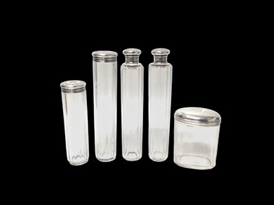 Lot 226 - Group of four Victorian silver topped vanity jars, (London 1885 / 1886), together with another continental example, (5).