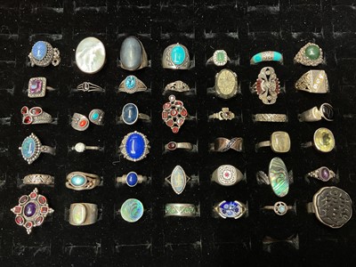 Lot 138 - Collection of 42 silver and white metal gem set rings, in a ring display case
