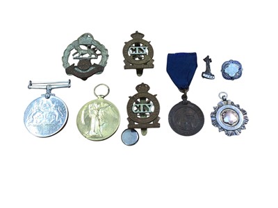 Lot 5059 - Two war medals and military cap badges