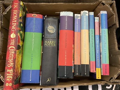 Lot 1386 - Harry Potter - three first editions and other publications together with case metal Platform 9 3/4 sign