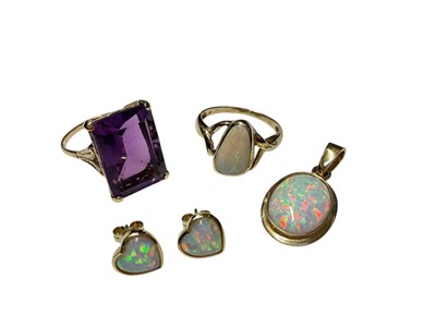Lot 302 - Yellow metal opal ring, simulated opal pendant and pair of earrings, and an amethyst ring