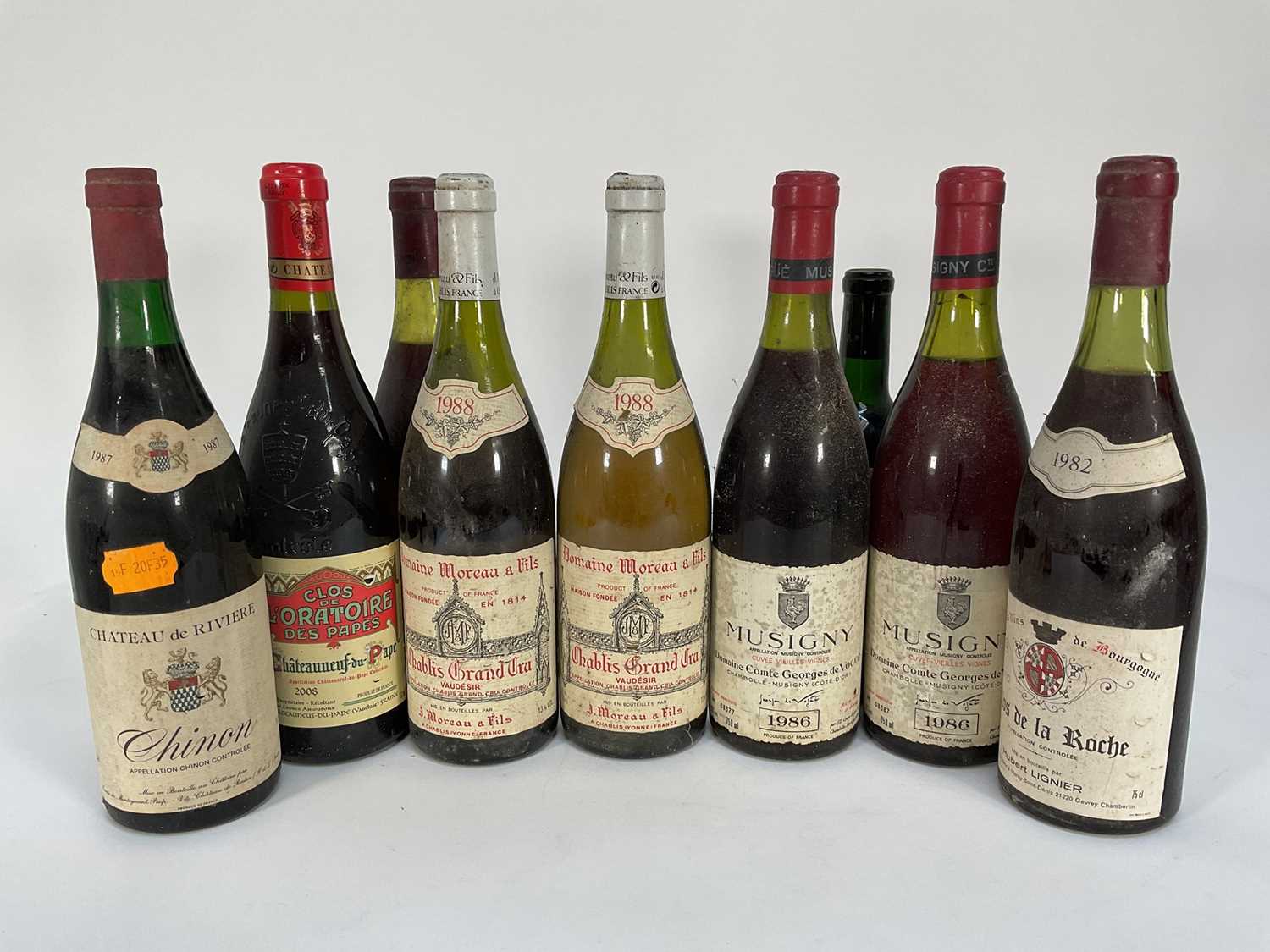 Lot 19 - Nine bottles of wine including: Chablis Grand Cru 1988, Musigny 1986, Clos de L'Oratoire des Papes 2008, Chateau de Riviere Chinon 1987, half bottle of Chateau Bourgneuf 1959 and others