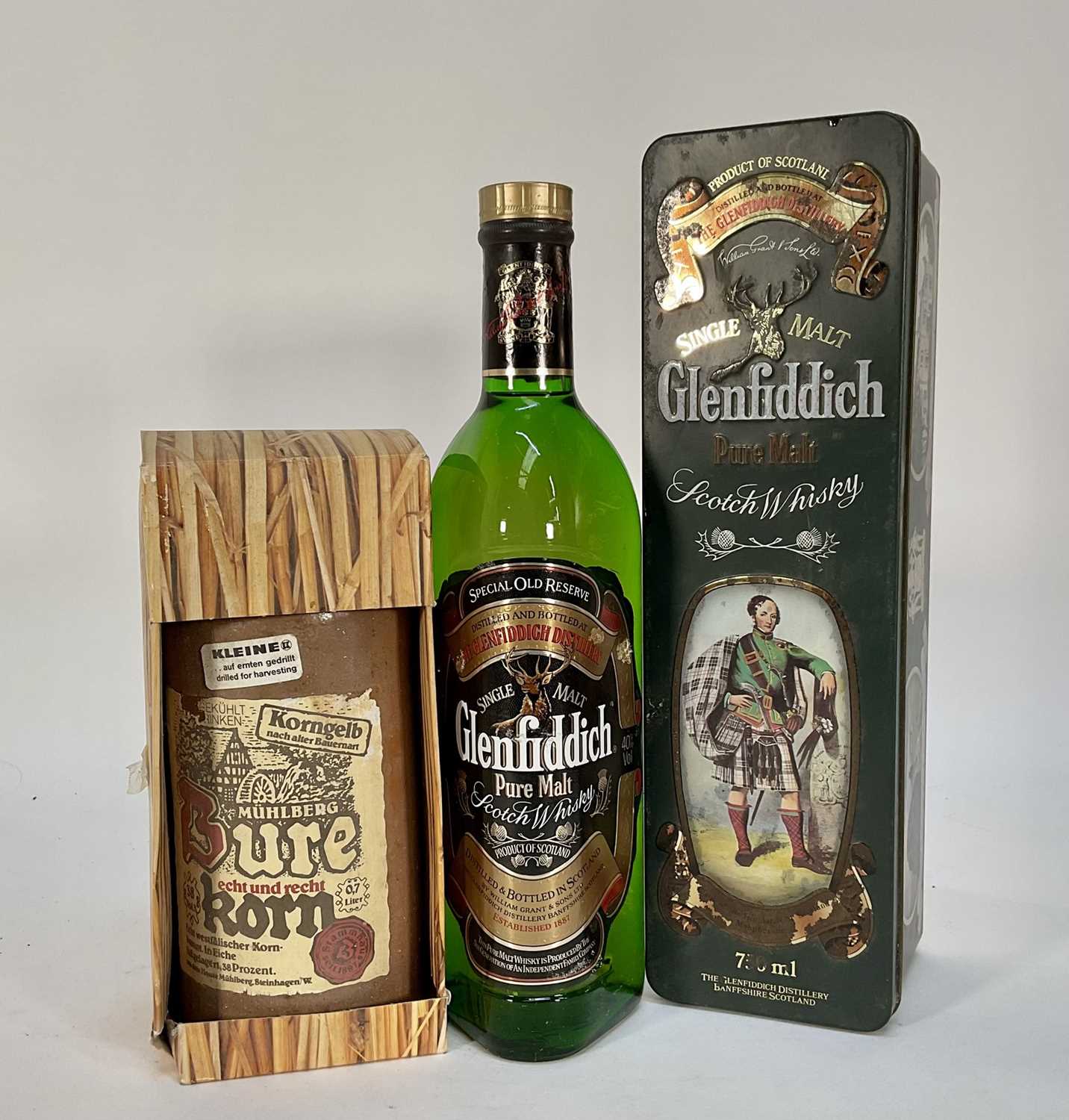 Lot 37 - Two bottles, Glenfiddich Pure Malt Scotch Whisky, 75cl., 40%, in Clan Macpherson tin and a bottle of Burekorn, boxed