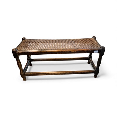 Lot 5343 - 1920s oak long foot stool with caned top on turned legs 86cm