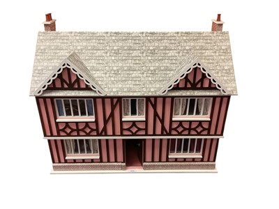 Lot 1944 - Dolls house wooden construction decorative exterior with pink walls, front opening with furnishings, curtains and floor coverings.