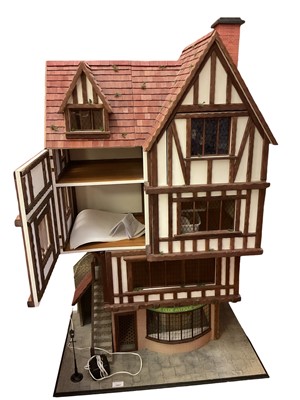 Lot 1947 - Dolls house four storey Tudor style wooden construction 'The Olde Antique Shoppe' on ground floor. Period style furnishings, accessories and figures. Front opening.
