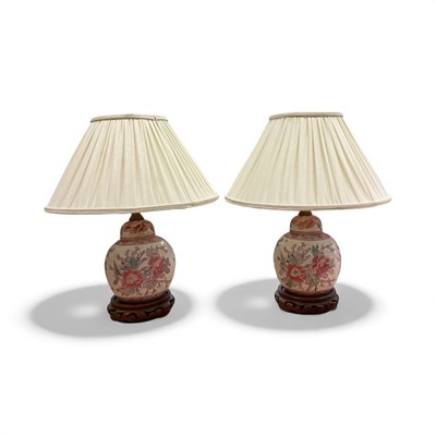Lot 5142 - A pair of porcelain bedside lamps in the Famille Rose pattern
