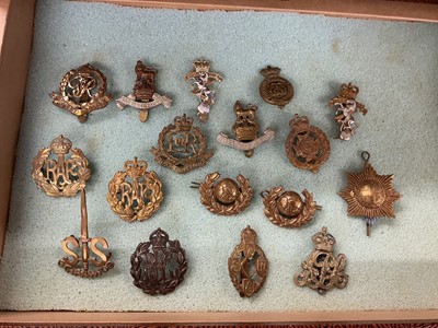 Lot 762 - Collection of seventy plus British Military cap badges to include Royal Defence Corps, Glider Pilot Regiment and Royal Flying Corps, housed in a four draw display cabinet.