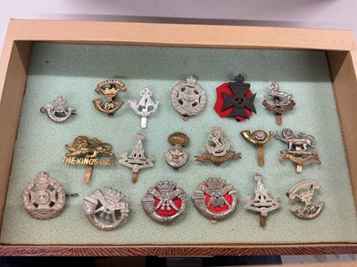 Lot 765 - Collection of forty British Military cap badges to include Cameron Highlanders, Duke of Cornwall Light Imfantry and Argyll and Sutherland Highlanders, together with GPO badges, housed in a four...