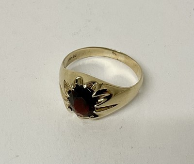 Lot 137 - 9ct gold signet ring with an oval mixed cut garnet in heavy 9ct gold setting, London 1971.