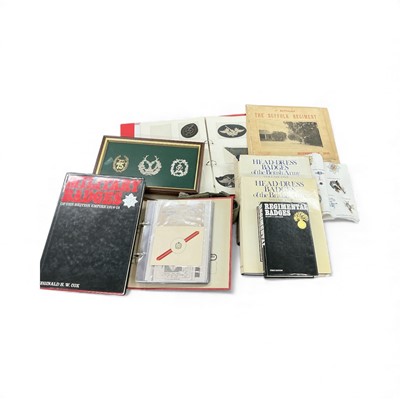 Lot 768 - Collection of assorted military related reference books, three Scottish cap badges in a glazed frame and group of cloth badges in an album, (1 box)