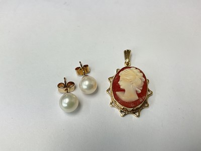 Lot 205 - Italian carved shell cameo pendant in 9ct gold mount, 31mm, together with a pair of 7mm cultured pearl stud earrings.