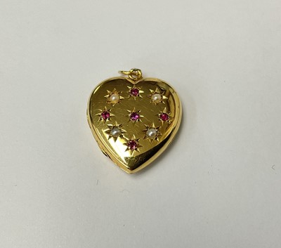 Lot 201 - Victorian style 9ct gold ruby and seed pearl heart-shaped locket, the front with ruby and diamond star design, hallmarked Birmingham 1966, 20mm.