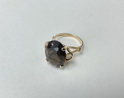 Lot 208 - Smokey Quartz dress ring with an oval mixed cut smokey quartz in 9ct gold setting, London 1971.