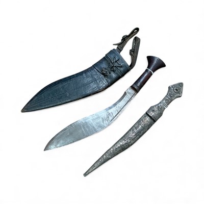 Lot 837 - Old Gurkha Kukri in leather covered sheath, together with a Middle Eastern dagger in white metal covered scabbard, (2).