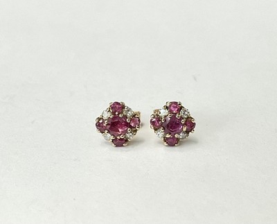 Lot 204 - Pair of ruby and diamond daisy cluster earrings with mixed-cut rubies and single cut diamonds in 9ct gold setting, London 1979. Diameter 7.5mm
