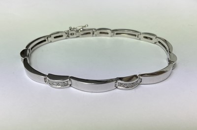 Lot 210 - Contemporary 18ct white gold and diamond bracelet with polished white gold links interspaced by brilliant cut diamonds, 18.5cm