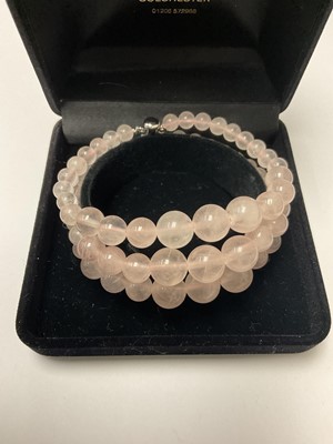 Lot 139 - Rose quartz bead triple-strand bracelet with silver clasp